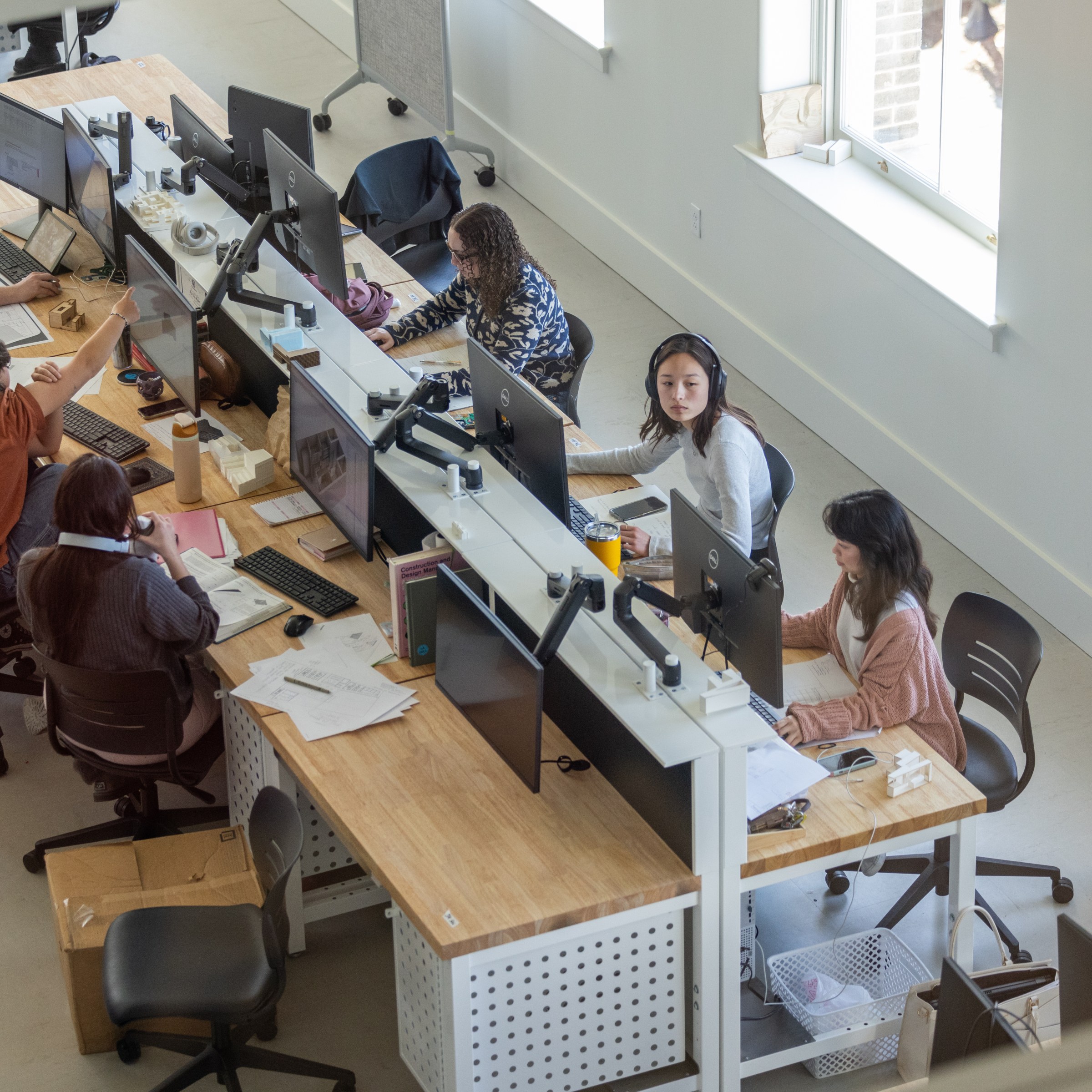 Angle view from above of students working on a row of studio desks in newly renovated Richardson Memorial Hall.